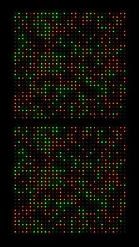 Abstract orange and green dots on square grid on dark background. Vertical motion graphic

