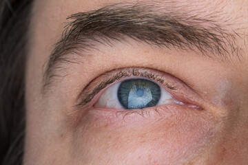 Caucasian male blue eye, close up studio shot, natural look, no makeup
