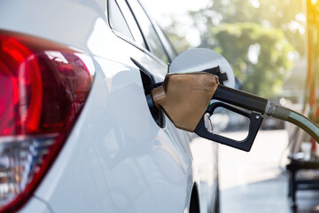 Pumping gasoline fuel in car at gas station.concept Travel,price oil,industrail business and...