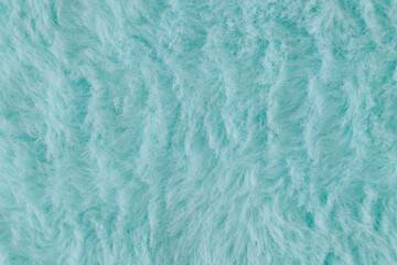 Light blue faux fur background. Close up surface wool texture. Minimal background concept. Trendy color luxury layout. Fluffy fur flat lay. Retro fashion aesthetic idea. Copy space.