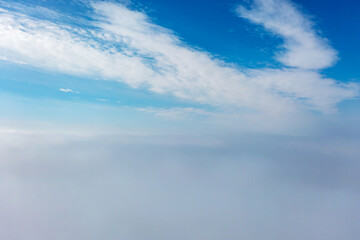 Aerial view of the city in the fog. Skyscrapers above the fog - 740566905