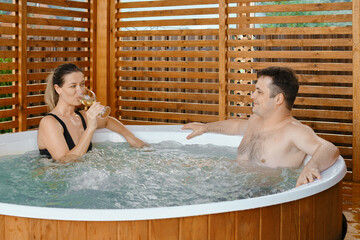 Couple in love spending time together in outdoor hot tub