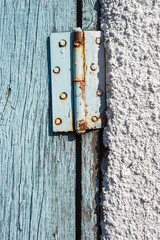 Hinges on doors. Wooden surface with old blue paint. Old wooden boards. Close-up. Background. Texture