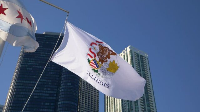Illinois flag waving in slow motion with skyscrapers and blue skies in the background, 4K slow motion