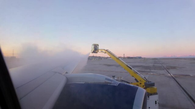 De-icing a commercial airplane on the runway