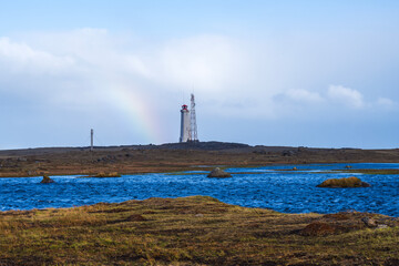 Stokksnes Lighthouse on iceland with a rainbow in summer
