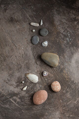 Fototapeta na wymiar Sea flat stones on a dark background