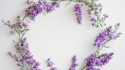 Delicate flowers of lavender and other purple flowers, arranged in a wreath on a white and delicate background - ideal for design and creative projects.