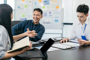 Asian young business people discussing on performance revenue in meeting. businessman working with co-worker team. financial adviser analysing data with investor.