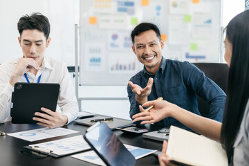 Business corporate team brainstorming, planning strategy having a discussion Analysis investment researching with chart at office desk documents in office.