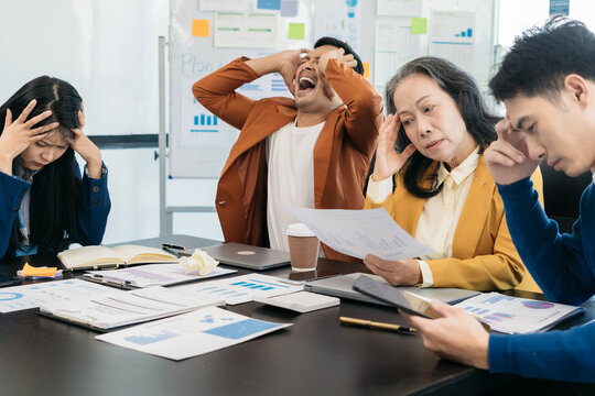 Business People, Teamwork, People And Crisis Concept - Business Team Sitting Sad And Solving Problems In The Office.