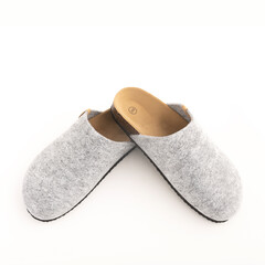 Top view Cozy gray slippers on white floor