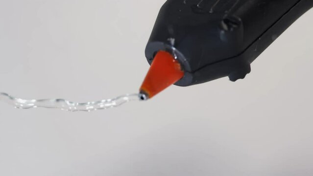 hot glue gun, applying hot glue, apartment renovation, construction, builder using hot glue gun