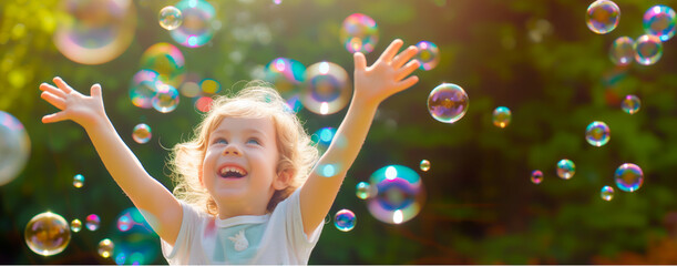 Joyful child playing with bubbles outdoors.