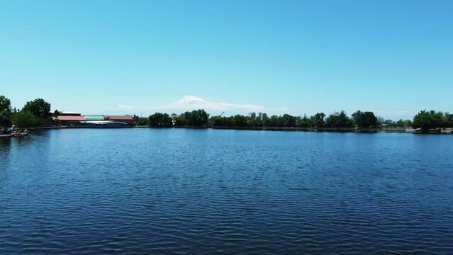 Drone footage of Erevan's lake with snow-capped Mount Ararat in the backdrop, showcasing Armenia's stunning scenery.