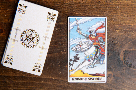 London, UK: 4 January, 2024: Minor Arcana - Knight of Swords of Tarot Card of Rider Waite deck on wooden background