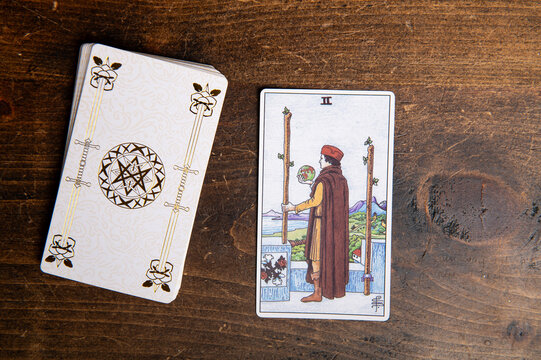 London, UK: 4 January, 2024: Minor Arcana - Two of Wands of Tarot Card of Rider Waite deck on wooden background