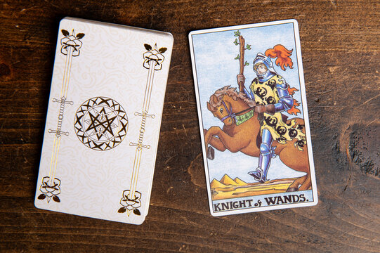 London, UK: 4 January, 2024: Minor Arcana - Knight of Wands of Tarot Card of Rider Waite deck on wooden background