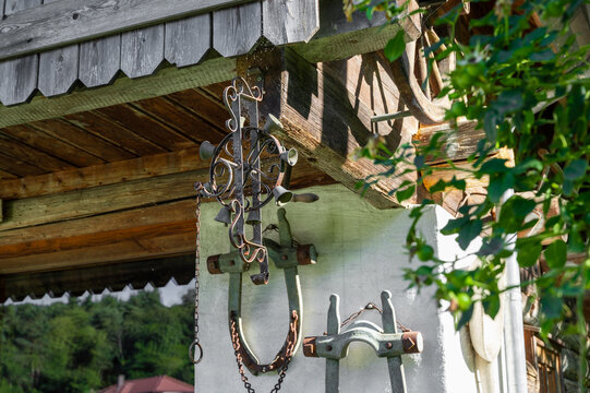 the facade of an old house is decorated with old horse collar