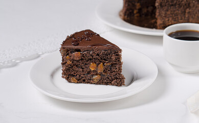 Chocolate cake with chocolate cream on a light table in a cafe
