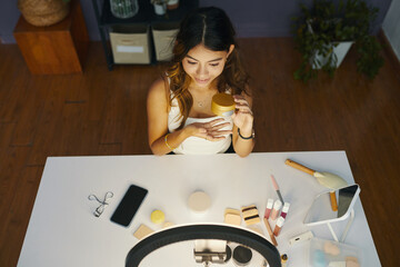 Teenage beauty blogger filming face mask review, top view