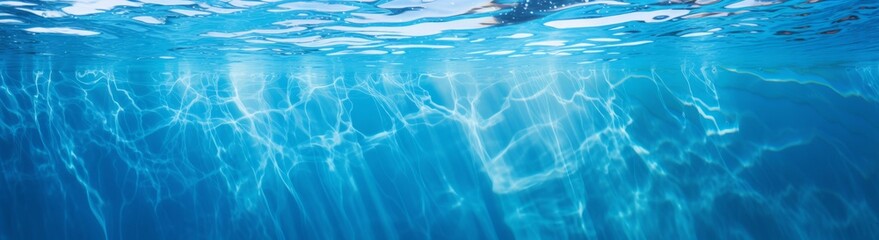 Naklejka premium Underwater panorama of swimming pool water with sun reflections, panoramic banner background