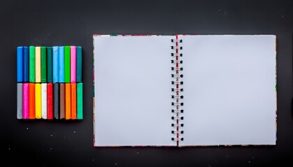 notebook with colorful pencils