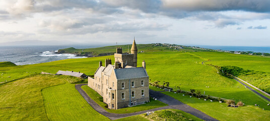 Classiebawn Castle on a backdrop of picturesque landscape of Mullaghmore Head. Spectacular sunset...