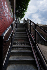 Fototapeta premium London - 06 03 2022: Iron staircase leading from Regent's Canal Towpath to Camden Road.