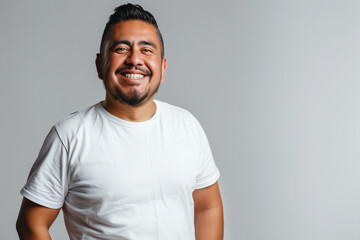 Confident Man Smiling in White T-Shirt Against Neutral Background: A Portrait of Positivity and Assurance