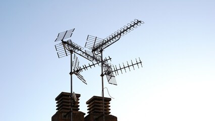 rooftop television antennas against the sky