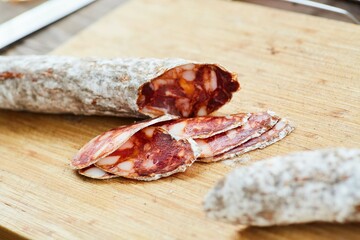Slicing dried sausage into thin slices. Preparation of sandwiches or dishes based on this product. The process of making food