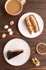 Chocolate biscuit cake with caramel cream on brown wooden. top view, flat lay.