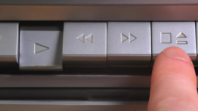 old tape recorder, pressing the play button on an old tape recorder, buttons of an old tape recorder, old equipment