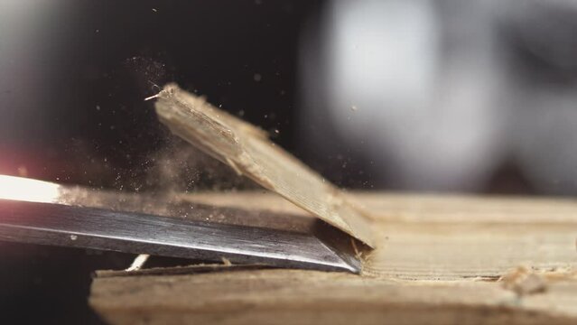 Witness the meticulous process of wood carving as a chisel works its magic in slow motion, capturing the essence of craftsmanship.
