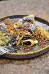 potato dough, filled with prune jam, sprinkled with poppy seeds and gingerbread, a traditional Czech sweet dish