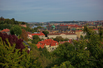 Panoramic view of the city of Prague from the observation deck. Streets and architecture of the old city. Romantic town panorama, historical buildings, red roofs, churches.