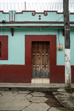 Classic Wooden Door on Vibrant Turquoise and Red Facade, Mexico travel