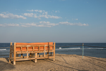 cozy bench at the highest place from the beach with a wonderful view to the sea