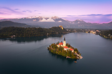 Elevated view with panoramic blue hour dusk night of Lake Bled Island Blejsko jezero with Bled city...