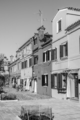 Black and white houses on Burano island, Venice, Veneto region, Italy - 740643500