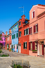 Brightly colored houses on Burano island, Venice, Veneto region, Italy - 740643772