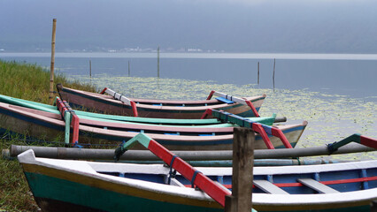 Colorful wooden fishing boats in the edge of the lake. Beratan Lake Bedugul, Bali, Indonesia