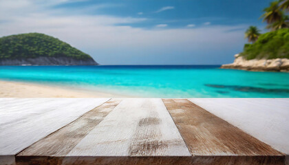 Fototapeta premium Wooden deck or table overlooking a serene tropical white sandy beach, clear turquoise ocean, and lush green island
