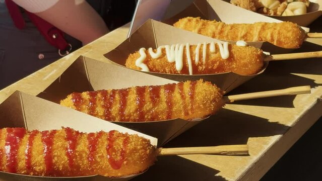 Deep frying activity in cooking by street food market.