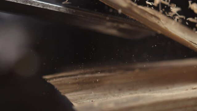  Explore the grace and finesse of woodworking as a chisel shapes wood in slow motion, showcasing the beauty of handcrafted creations.