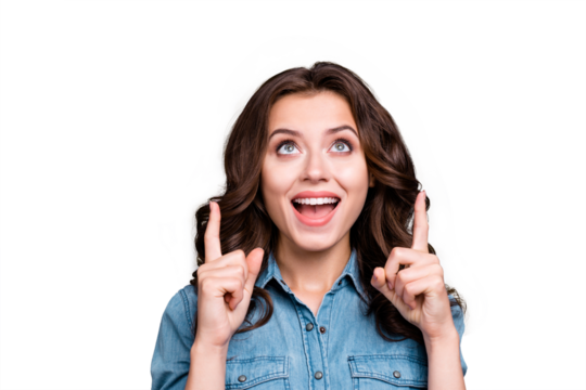 Portrait of dreamy stylish nice cute funny lovely attractive cheerful girl with wavy hair in casual denim shirt, opened mouth, looking up, pointing two fingers up, isolated over grey background