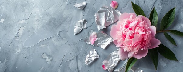 peony with pieces of foil with space for text.