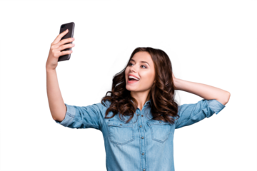 Stylish trendy funny flirty nice cute cheerful adorable lovely attractive magnificent brunette girl with wavy hair in casual denim shirt, taking cool selfie on cam, isolated over grey background