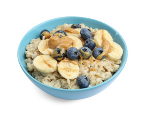 Tasty oatmeal with banana, blueberries and peanut butter in bowl isolated on white